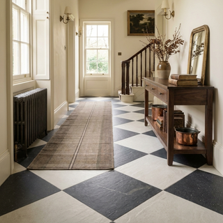 Stately hallway with checkered floor, wooden console table, and decorative elements.