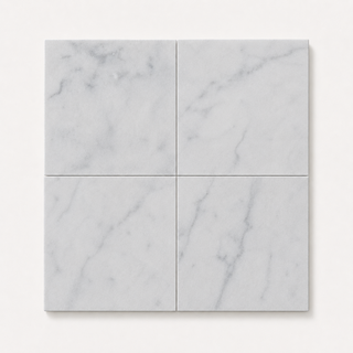 Four square white marble tiles arranged in a 2x2 chequer grid, showing soft gray veining and a matte finish