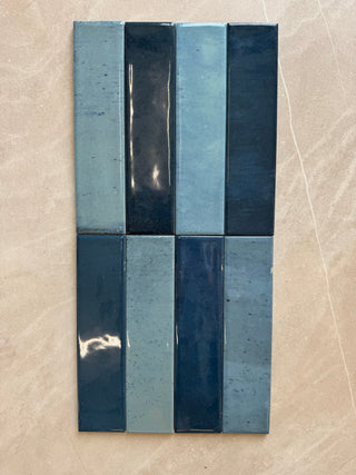 Rectangular tile with blue and black horizontal stripes on a beige background