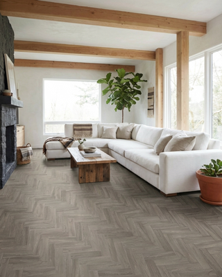 Modern farmhouse living room with white L shape sofa, wooden coffee table and herringbone patterned floor.