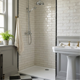 Bathroom with tiled shower, sink, and window