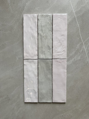 Set of six gray tiles arranged in a grid on a gray surface