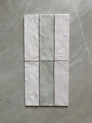 Set of six gray tiles arranged in a grid on a gray surface