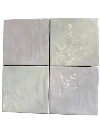 Four square tiles with marble-like pattern on a gray background