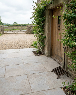 Cream Limestone Effect Tiles laid outside a front porch in a farmhouse 