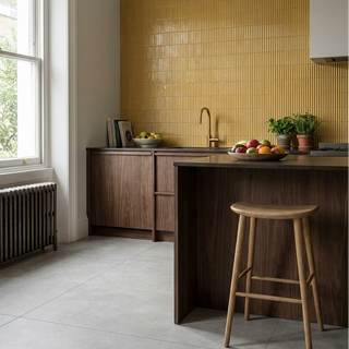 Modern kitchen with wooden island, yellow tiled backsplash, and natural light.
