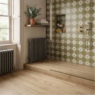 Bathroom with floral tiles, a shower, and a window.