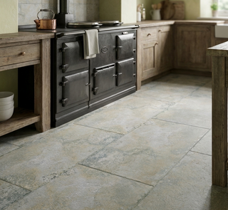 rustic kitchen with a large black stove and montpellier taupe porcelain floor tiles